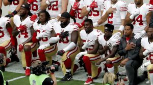 Mandatory Credit: Photo by AP/REX/Shutterstock (9101661f) Members of the San Francisco 49ers kneel during the national anthem as others stand prior to an NFL football game against the Arizona Cardinals, in Glendale, Ariz 49ers Cardinals Football, Glendale, USA - 01 Oct 2017