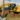 A man sits in an excavator and moves dirt in a cemetery